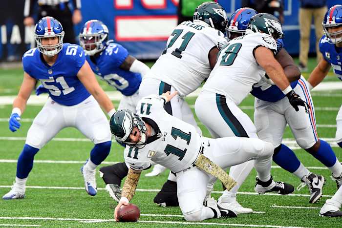 Nov 15, 2020; East Rutherford, New Jersey, USA; Philadelphia Eagles quarterback Carson Wentz (11) trips on a play against the New York Giants during the first half at MetLife Stadium.